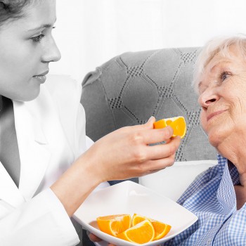 nutritionist-nurse-feeding-elderly-woman